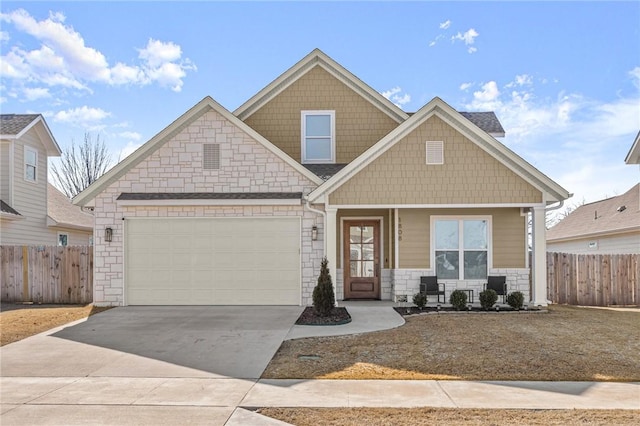 craftsman inspired home featuring a garage and covered porch