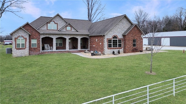 view of front of house with central AC unit, a garage, a front lawn, and a porch