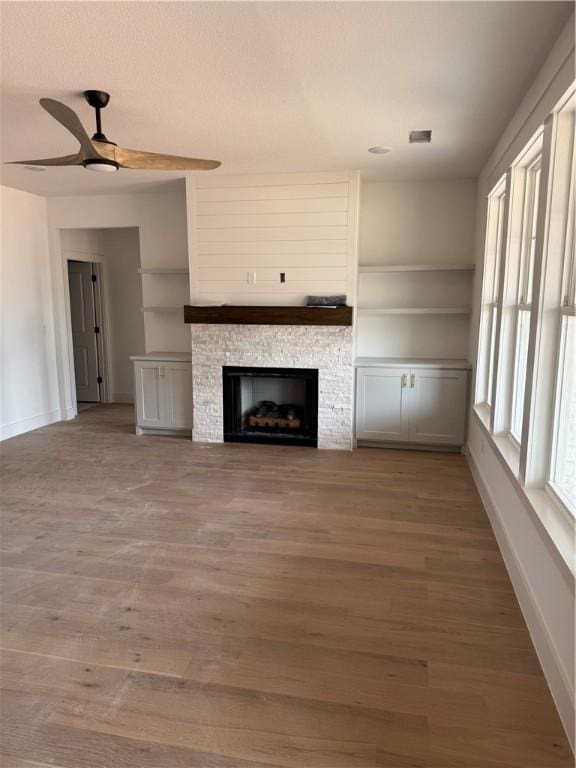 4750 Cowboy St, Springdale, AR 72762 - unfurnished living room featuring ceiling fan, wood finished floors, baseboards, and a fireplace