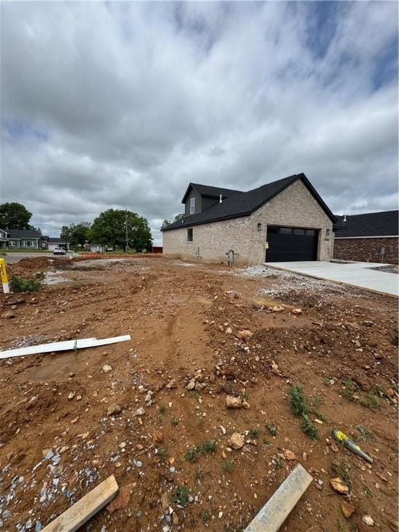 4750 Cowboy St, Springdale, AR 72762 - view of property exterior featuring an attached garage and concrete driveway