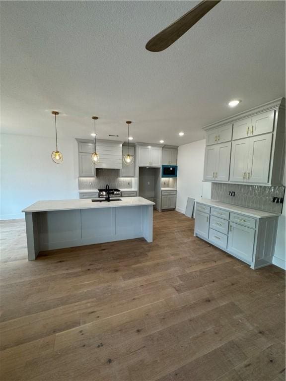 4750 Cowboy St, Springdale, AR 72762 - kitchen with a sink, backsplash, recessed lighting, baseboards, and wood finished floors