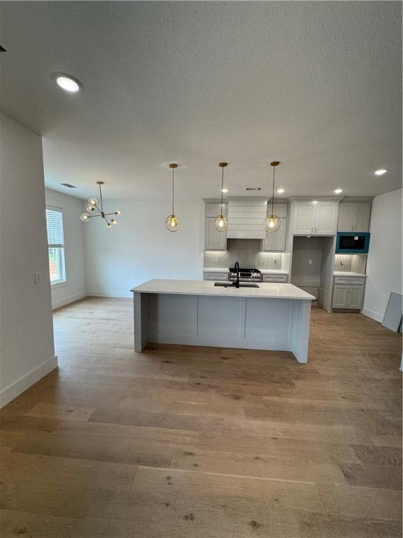 4750 Cowboy St, Springdale, AR 72762 - kitchen with a sink, tasteful backsplash, recessed lighting, baseboards, and light wood-style flooring