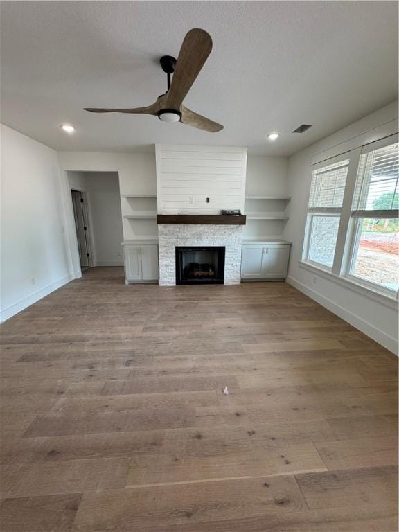 4750 Cowboy St, Springdale, AR 72762 - unfurnished living room featuring baseboards, ceiling fan, wood finished floors, recessed lighting, and a fireplace
