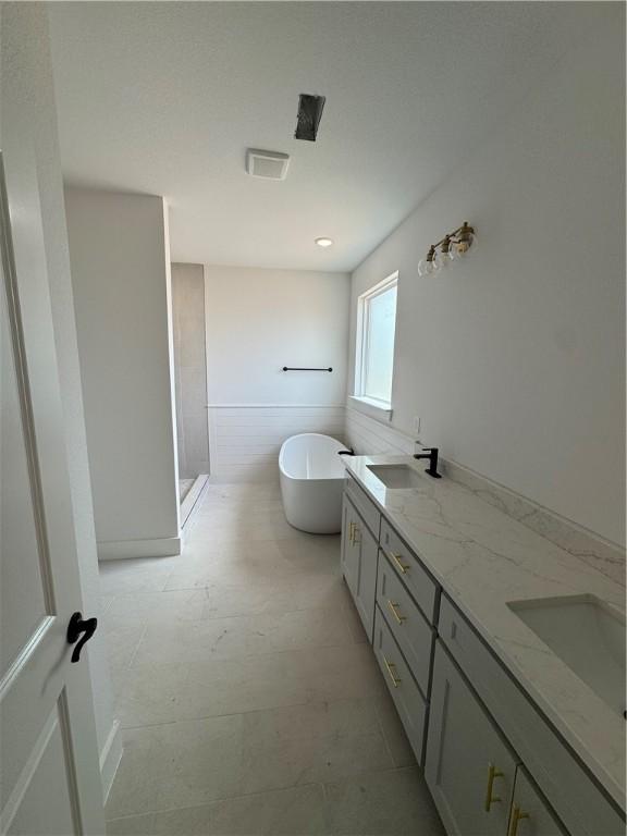 4750 Cowboy St, Springdale, AR 72762 - bathroom featuring a soaking tub, double vanity, and a stall shower
