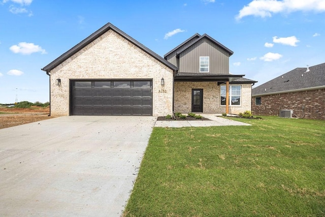 4750 Cowboy St, Springdale, AR 72762 - view of front of house featuring an attached garage, a front yard, concrete driveway, and brick siding