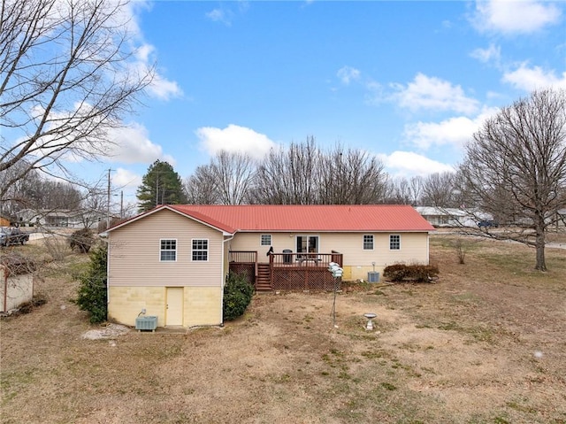 back of house with central AC and a deck