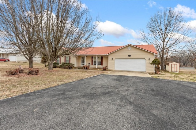 ranch-style home with a porch, a garage, a front lawn, and a shed