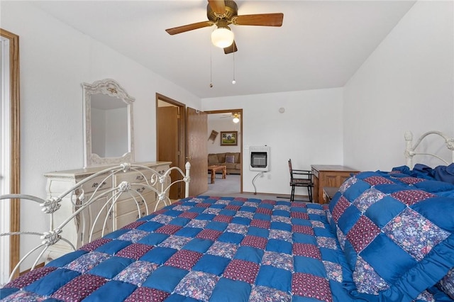 carpeted bedroom featuring heating unit and ceiling fan