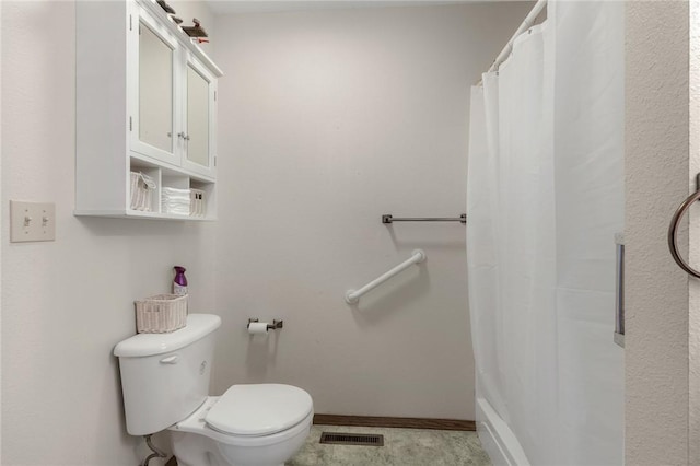 bathroom with a shower with curtain and toilet