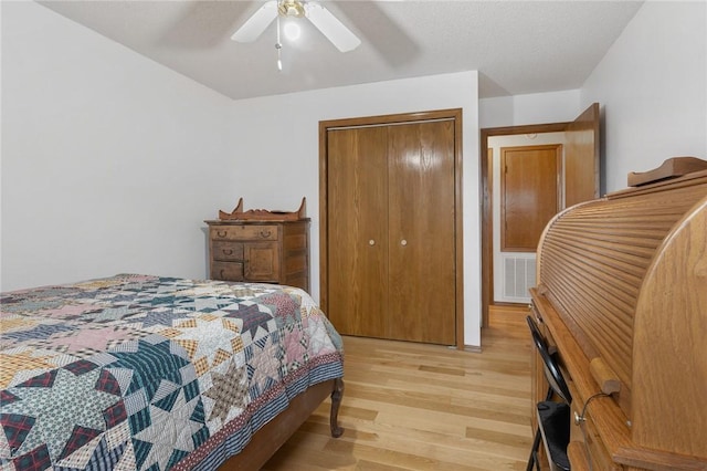 bedroom featuring a closet, ceiling fan, and light wood-type flooring