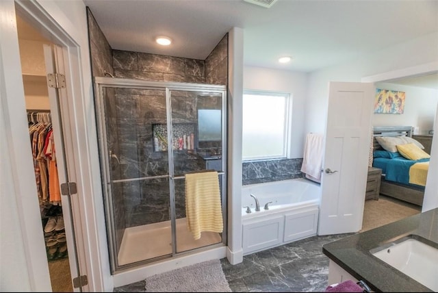 bathroom with vanity and independent shower and bath