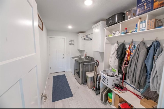 mudroom featuring independent washer and dryer and light hardwood / wood-style floors