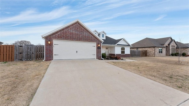 view of front of property with brick siding, a front lawn, fence, concrete driveway, and a gate