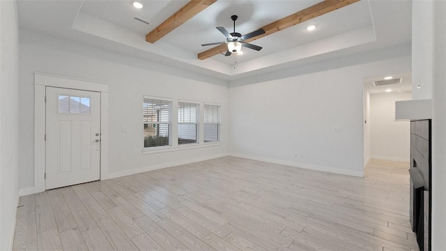 entryway featuring light wood-type flooring, beam ceiling, visible vents, a tray ceiling, and baseboards