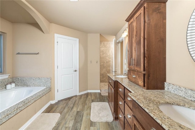 bathroom with vanity, hardwood / wood-style floors, and shower with separate bathtub