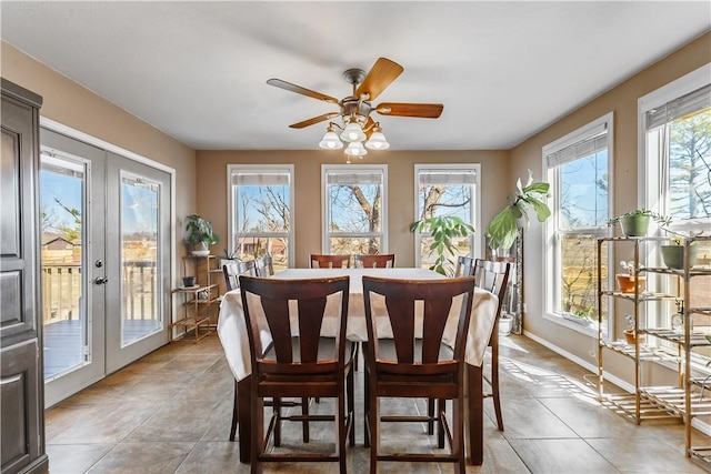 dining room with light tile patterned floors, plenty of natural light, baseboards, and french doors