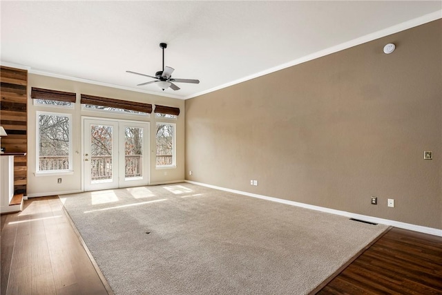 unfurnished room with visible vents, baseboards, ceiling fan, ornamental molding, and wood finished floors