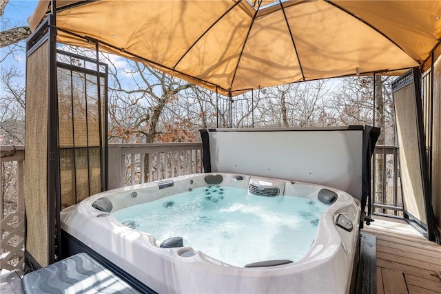 wooden deck with a hot tub