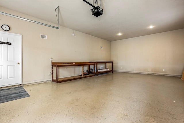 garage featuring recessed lighting, visible vents, and a garage door opener