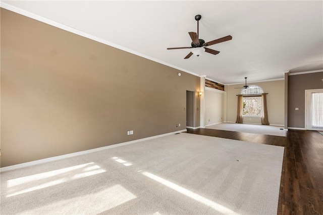 unfurnished living room featuring a ceiling fan, baseboards, dark wood-type flooring, and crown molding