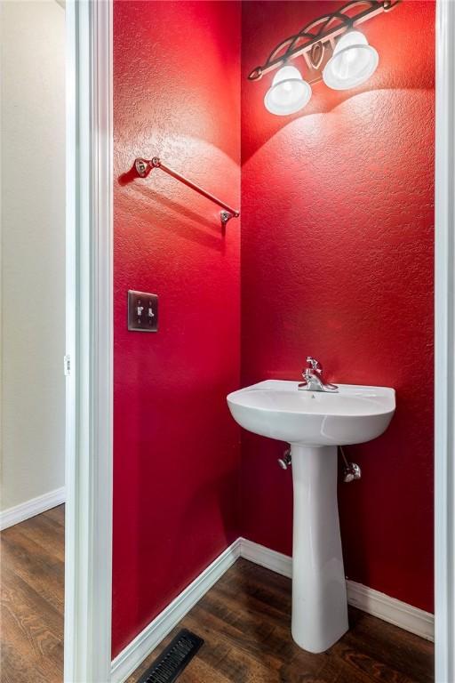 bathroom featuring baseboards and wood finished floors