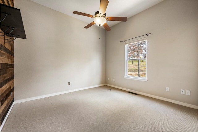 spare room featuring a ceiling fan, carpet, visible vents, and baseboards