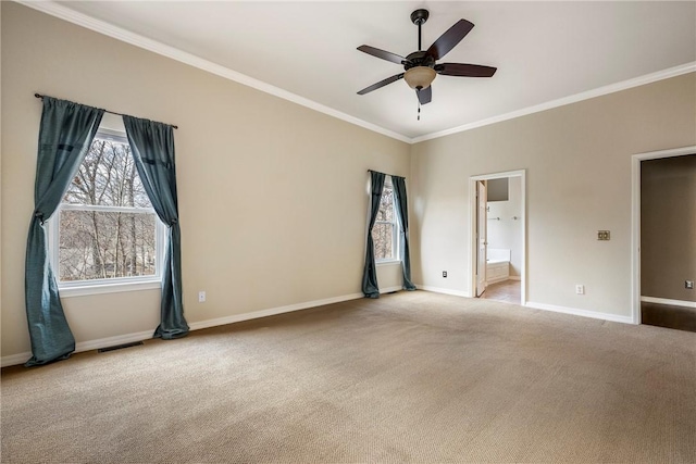 empty room featuring carpet, visible vents, baseboards, and ornamental molding