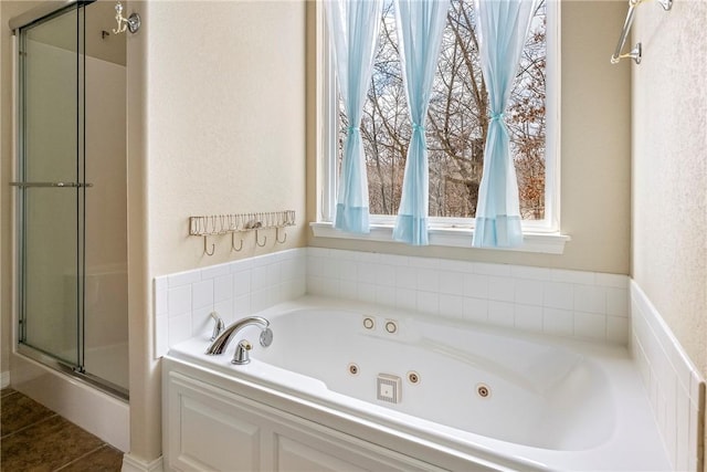 bathroom with a whirlpool tub and a shower stall