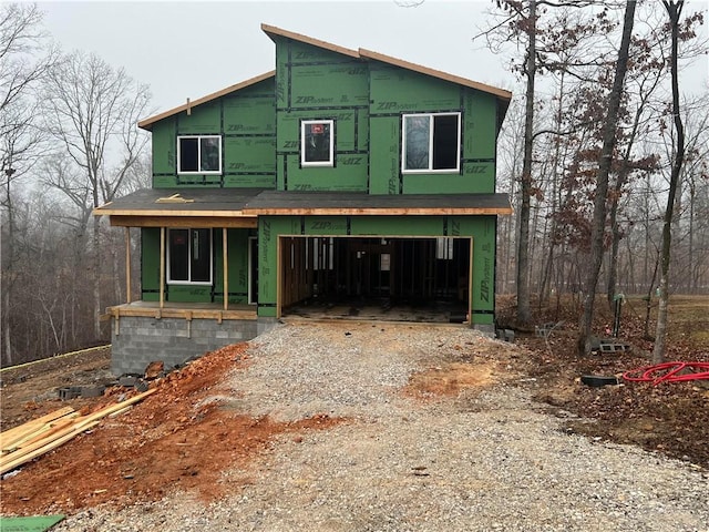 property in mid-construction with a garage and covered porch