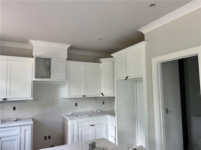18 Selland Ln, Bella Vista, AR 72715 - kitchen featuring ornamental molding and white cabinets