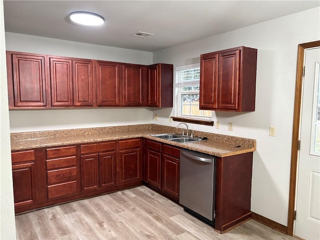 kitchen with light stone countertops, sink, stainless steel dishwasher, and light hardwood / wood-style floors