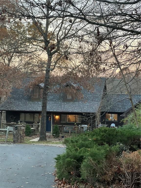 rear view of house featuring covered porch