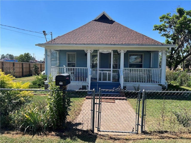 bungalow featuring a porch and a front yard