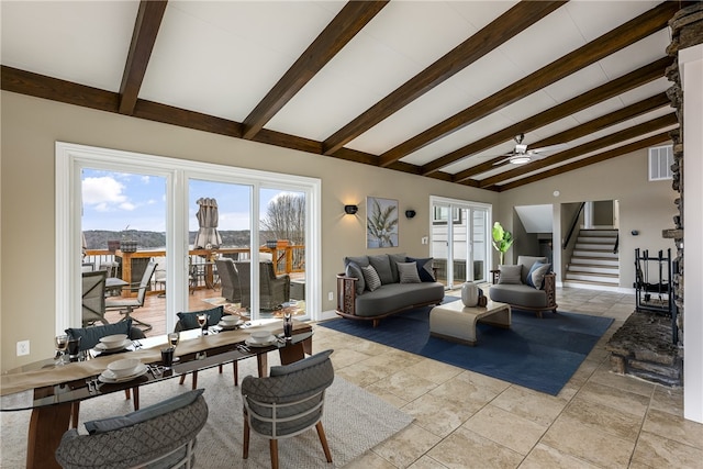 living room featuring a healthy amount of sunlight, vaulted ceiling with beams, and ceiling fan