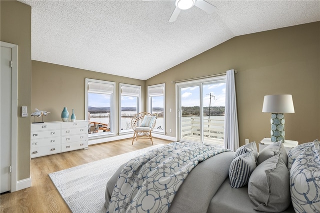 8116 Pine Ln, Rogers, AR 72756 - bedroom with access to exterior, lofted ceiling, wood finished floors, a textured ceiling, and a water view