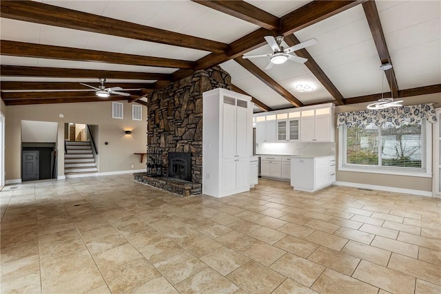 unfurnished living room with ceiling fan, vaulted ceiling with beams, light tile patterned floors, and a fireplace