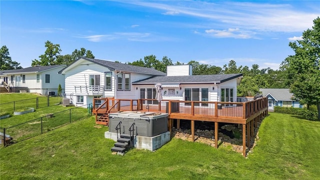 8116 Pine Ln, Rogers, AR 72756 - back of house featuring a deck, a chimney, a hot tub, and a shingled roof