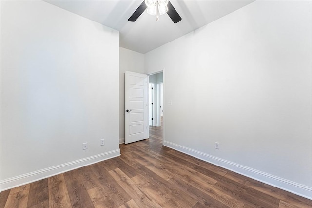 empty room with ceiling fan and dark hardwood / wood-style floors