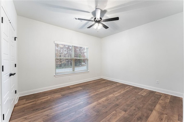 unfurnished room with ceiling fan and dark hardwood / wood-style flooring