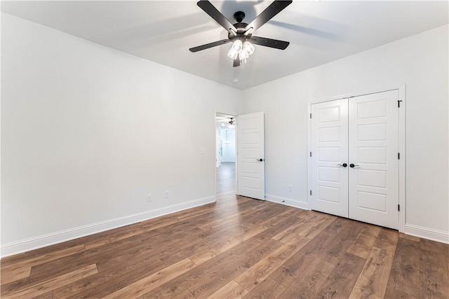 unfurnished bedroom featuring hardwood / wood-style floors, ceiling fan, and a closet