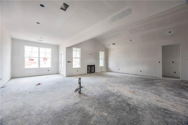 unfurnished living room featuring lofted ceiling and a fireplace