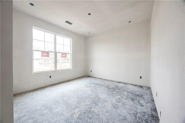 empty room with visible vents and unfinished concrete floors