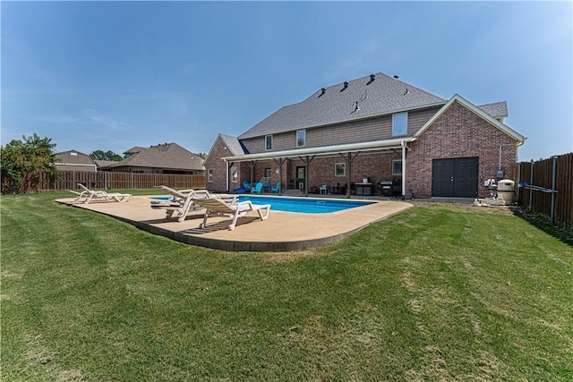 view of pool with a yard and a patio area