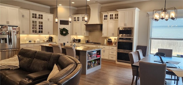 kitchen featuring light stone counters, stainless steel appliances, open floor plan, custom exhaust hood, and dark wood-style floors