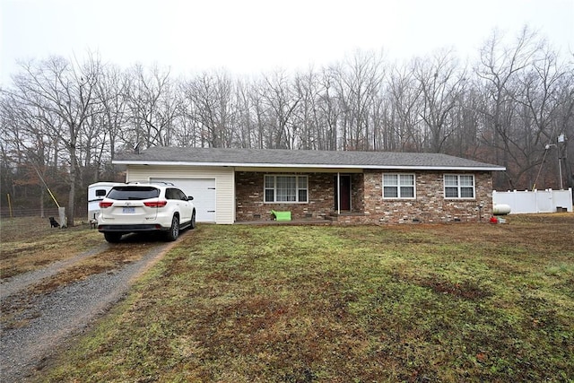 ranch-style home with a garage and a front lawn