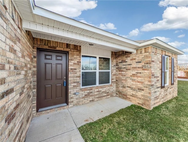 doorway to property with a yard