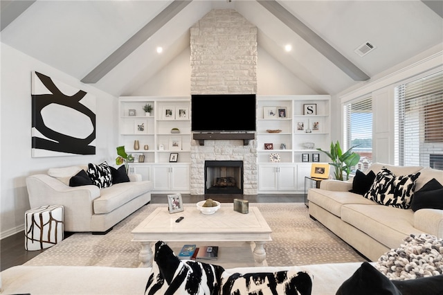 living room featuring beam ceiling, hardwood / wood-style flooring, a stone fireplace, and high vaulted ceiling