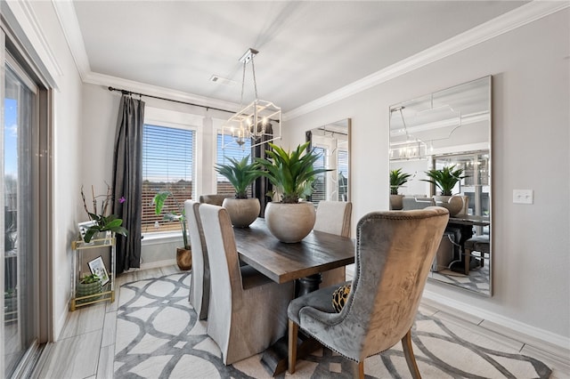 dining area featuring crown molding and a notable chandelier