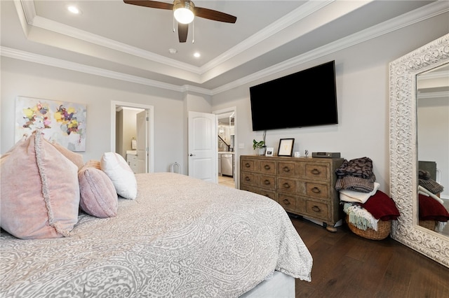 bedroom featuring crown molding, dark hardwood / wood-style floors, and a raised ceiling