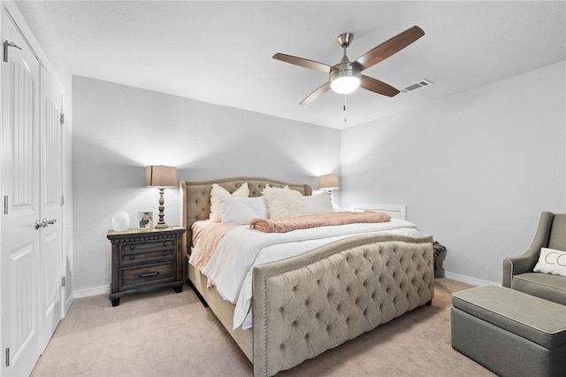 bedroom with light carpet and ceiling fan